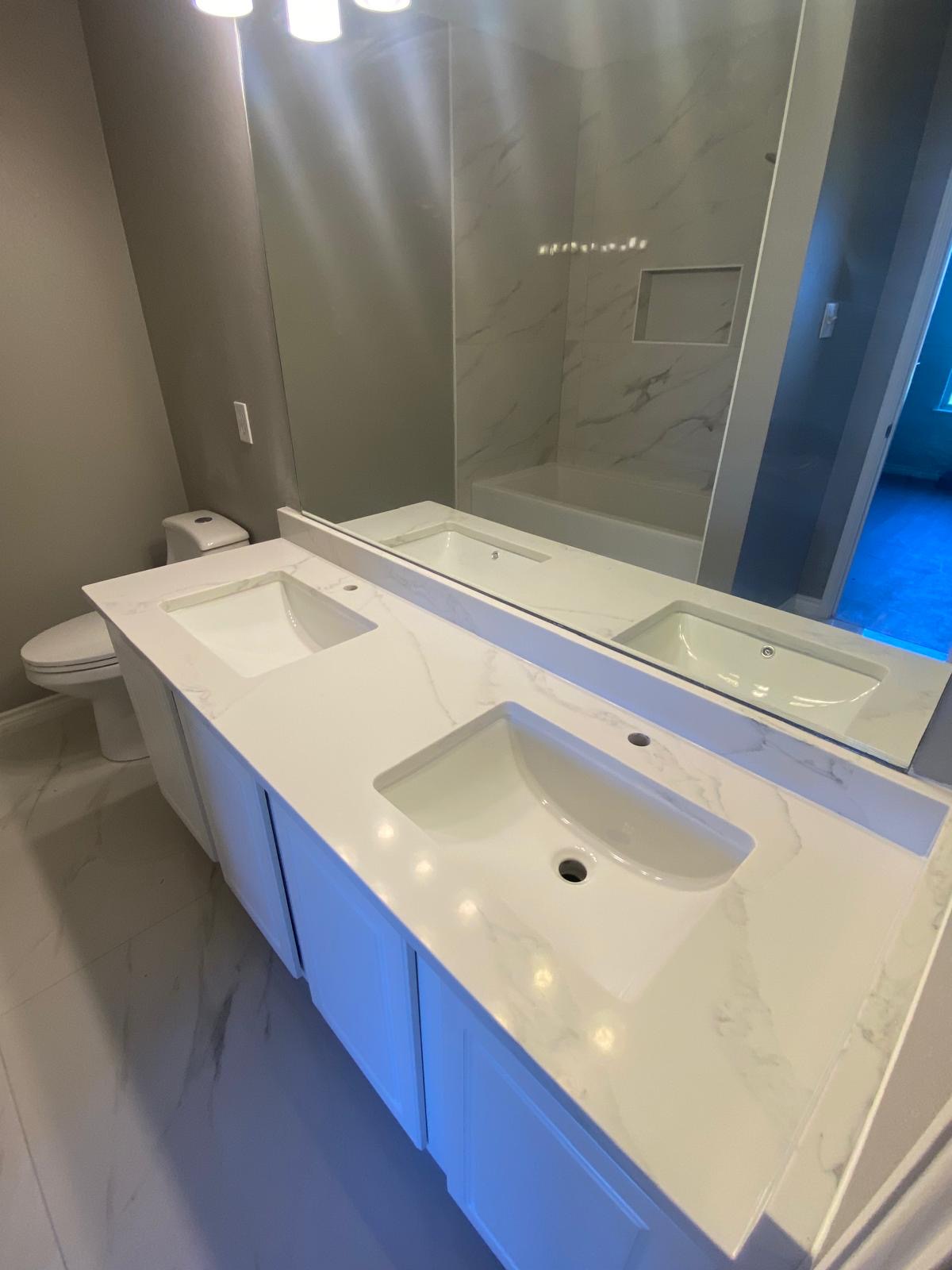 Master bathroom with marble countertops and tiling