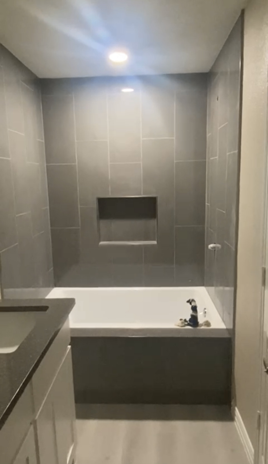 Bathtub surround clad in granite